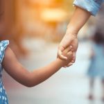 Mother and daughter holding hand together with love in vintage color tone